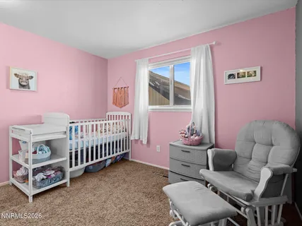a bedroom with furniture and a window