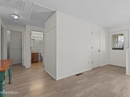 a view of empty room with wooden floor