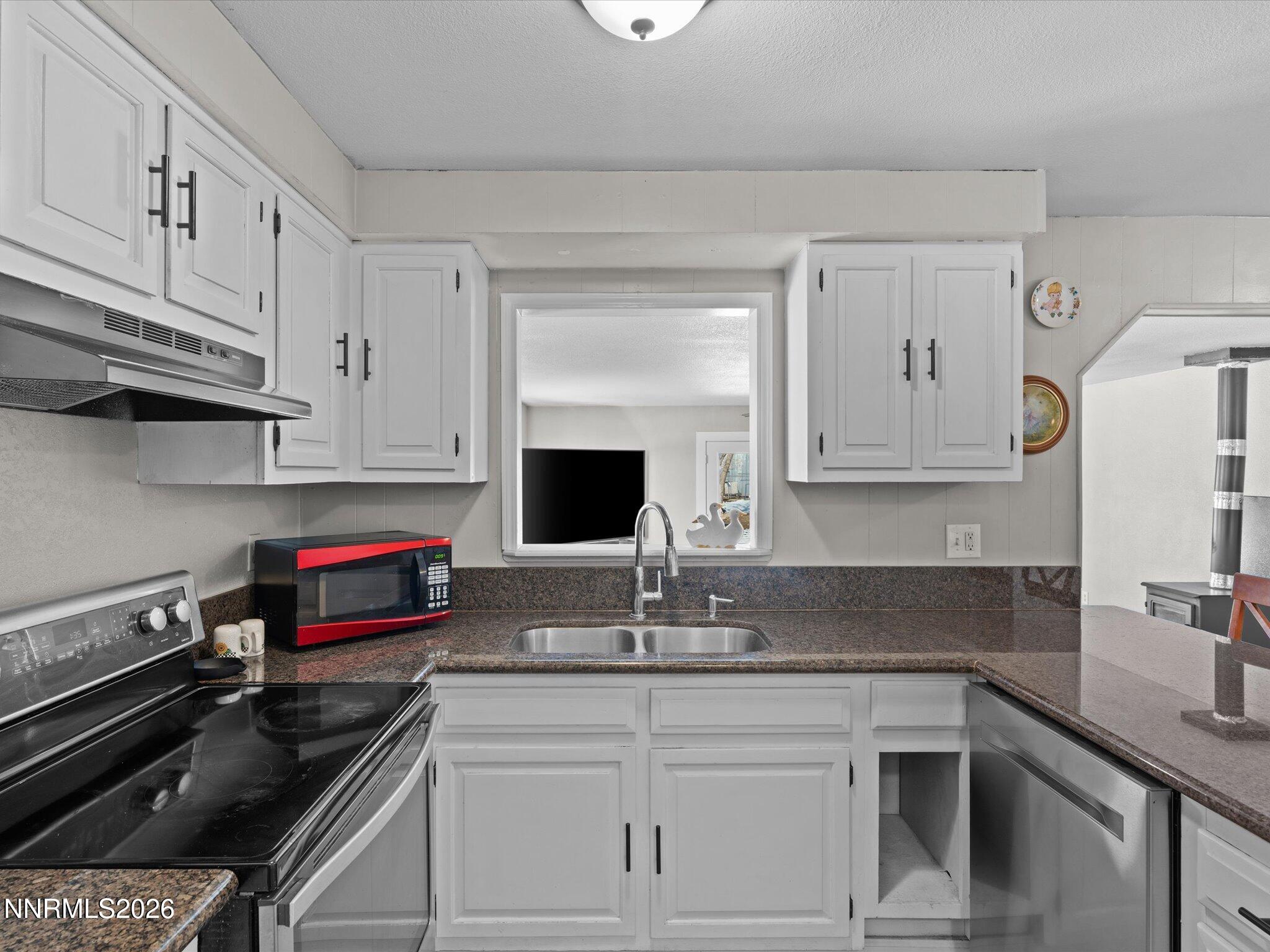 151 Roughing It Road Dayton, NV 89403 - Photo 8 of 25 a kitchen with granite countertop a sink and cabinets