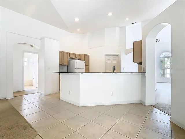 an empty room with windows and mirror