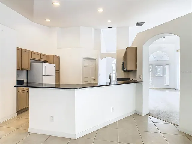 an empty room with a ceiling fan and a window