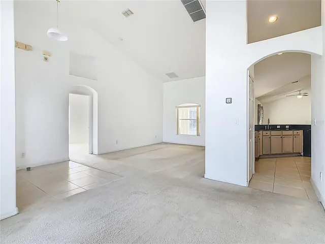 an empty room with a empty space and a ceiling fan