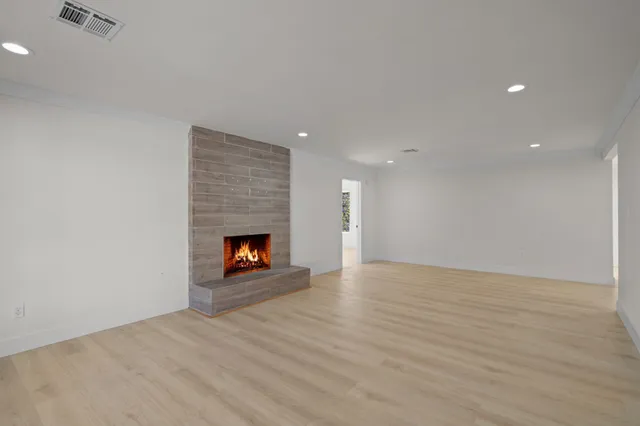 a view of an empty room and fire place