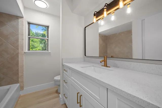 a view of an empty room with closet and a window