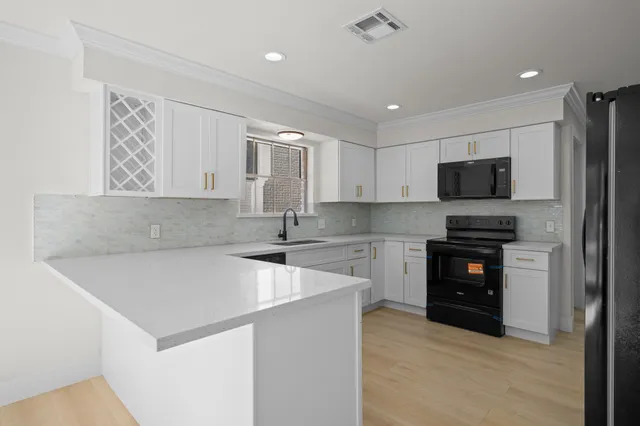 a kitchen with a refrigerator and a stove top oven
