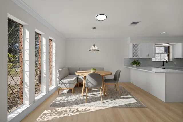 a view of a dining room with furniture window and wooden floor