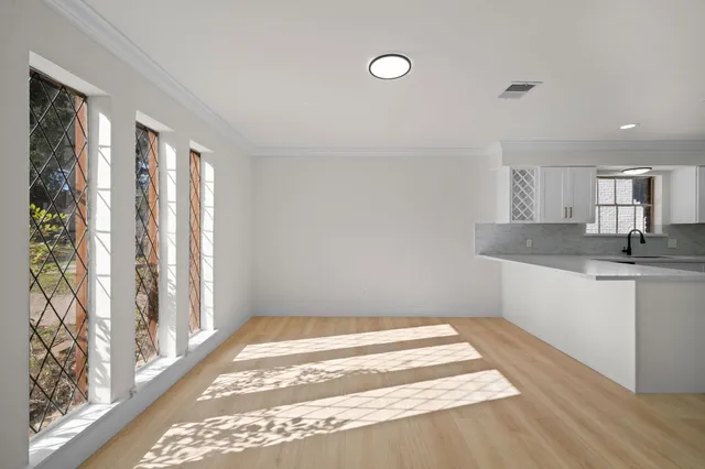 a bathroom with a granite countertop sink and a window