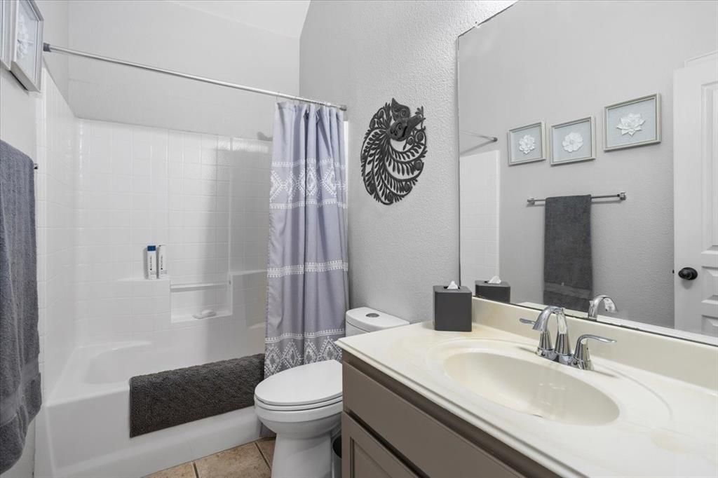 8312 Teja Trail Benbrook, TX 76126 - Photo 17 of 23 a bathroom with a sink a toilet and shower