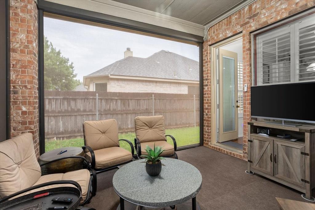 8312 Teja Trail Benbrook, TX 76126 - Photo 20 of 23 a living room with patio furniture and a flat screen tv