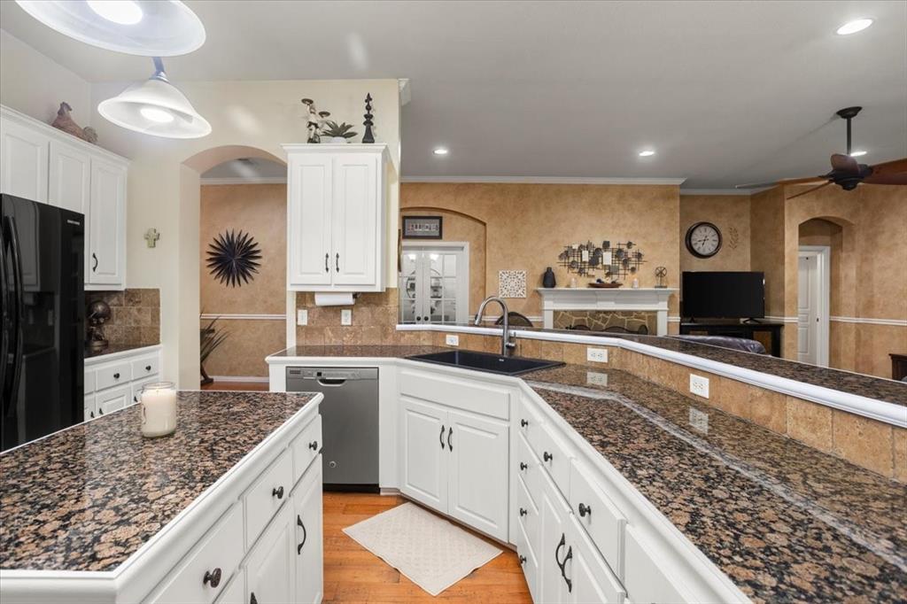 8312 Teja Trail Benbrook, TX 76126 - Photo 7 of 23 a large kitchen with stainless steel appliances granite countertop a lot of counter space and wooden floor