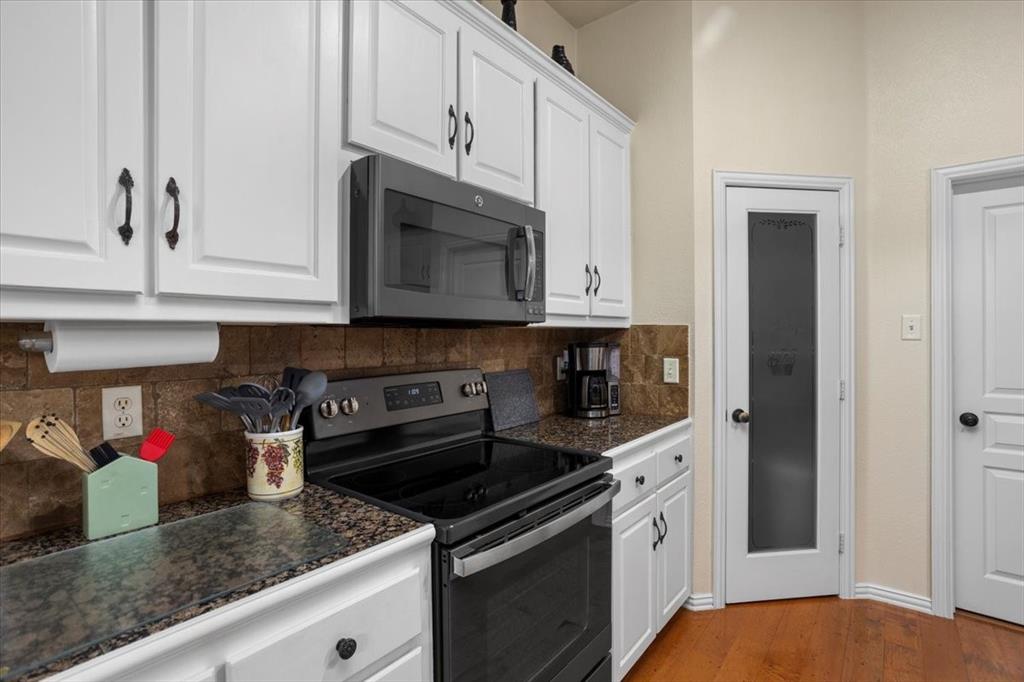 8312 Teja Trail Benbrook, TX 76126 - Photo 8 of 23 a kitchen with stainless steel appliances granite countertop white cabinets and a stove