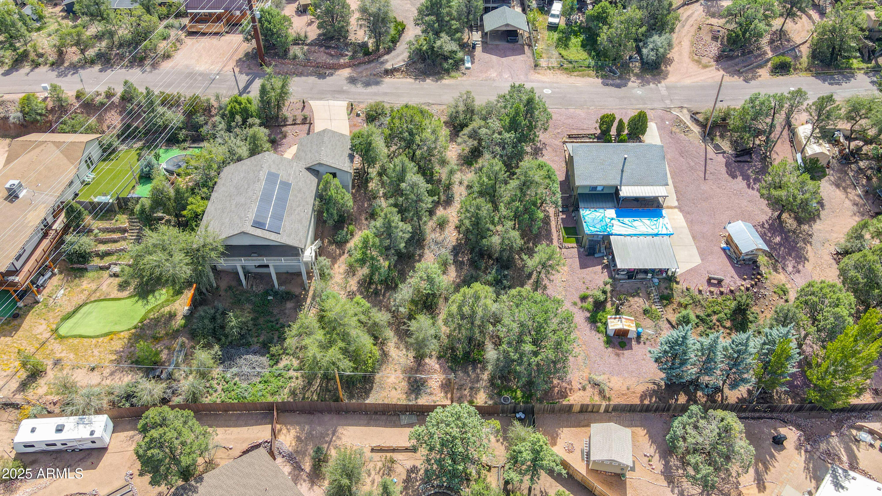 an aerial view of a house with a yard and lake view
