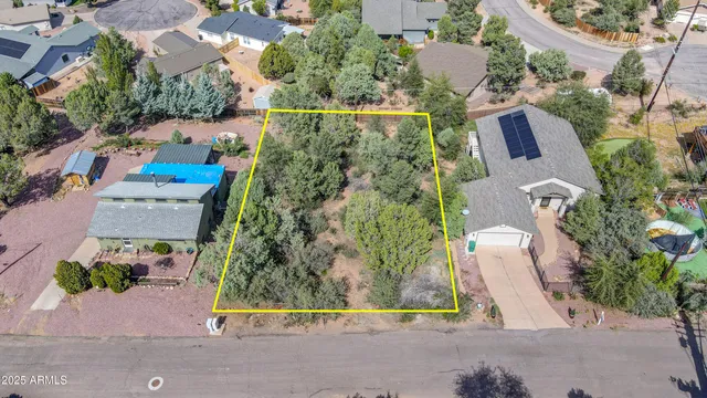 an aerial view of residential house with outdoor space and parking