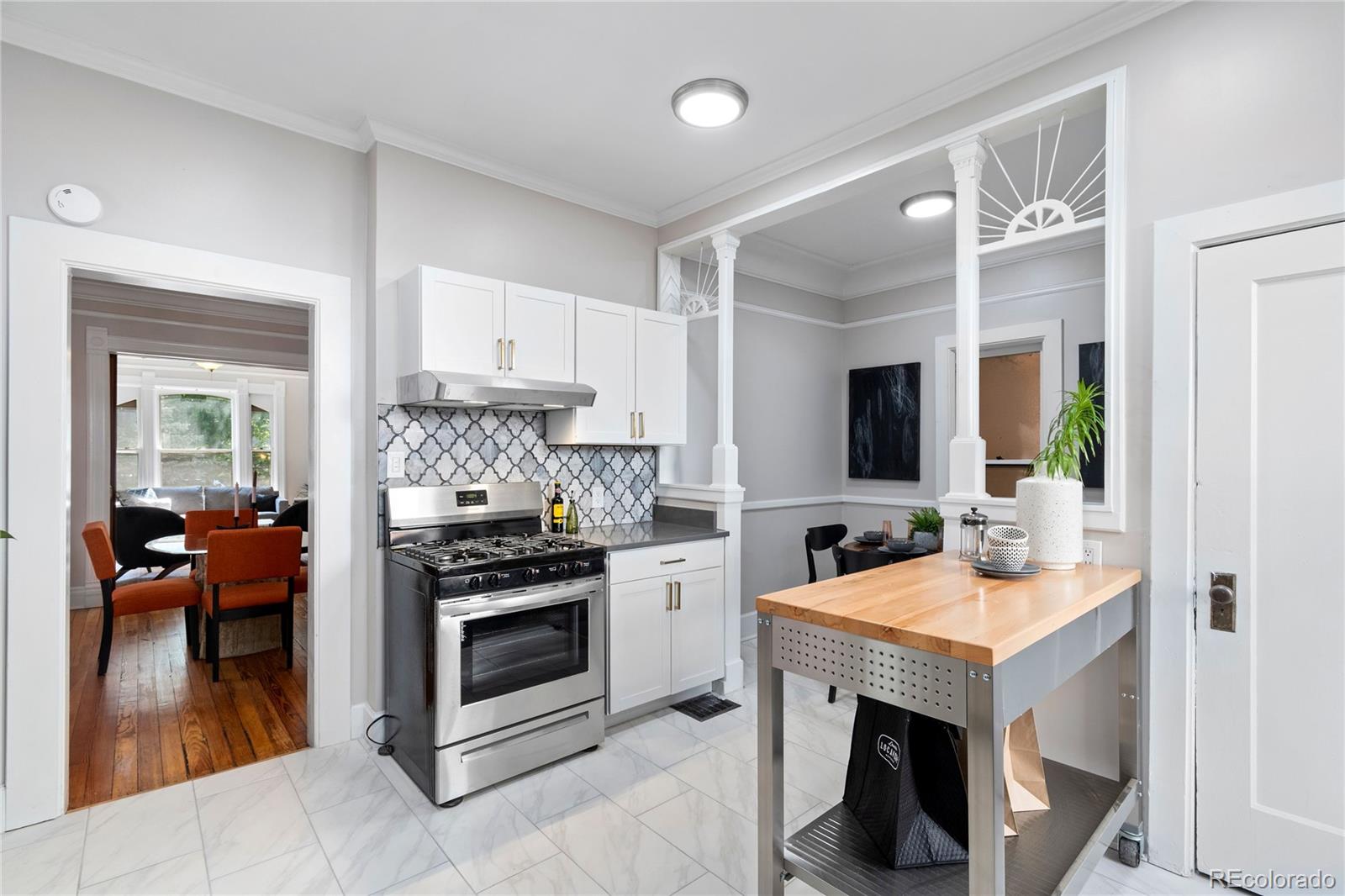 a kitchen with a stove and a white cabinets