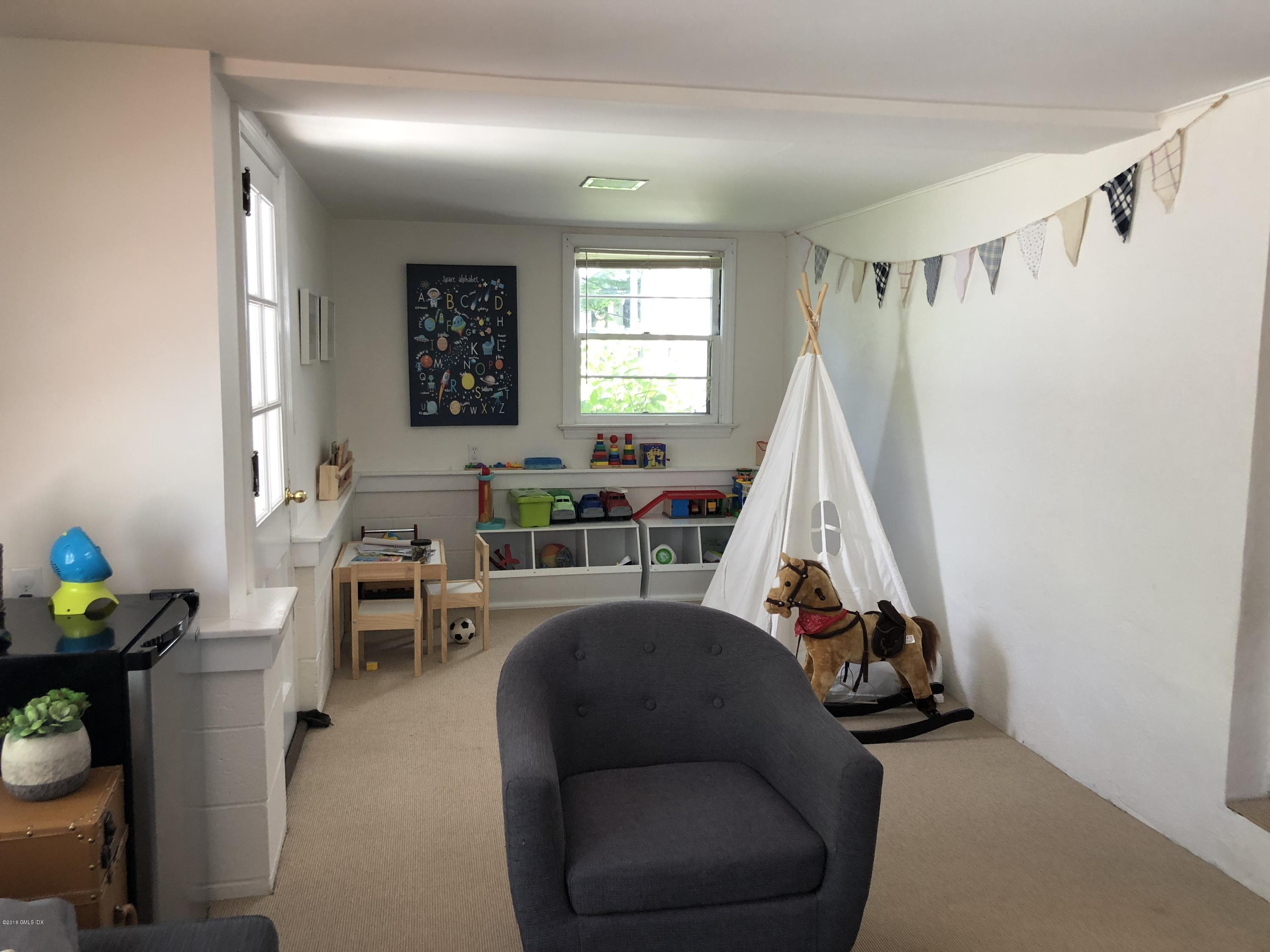 84 Indian Field Road Greenwich, CT 06830 - Photo 11 of 19 a living room with furniture and a window