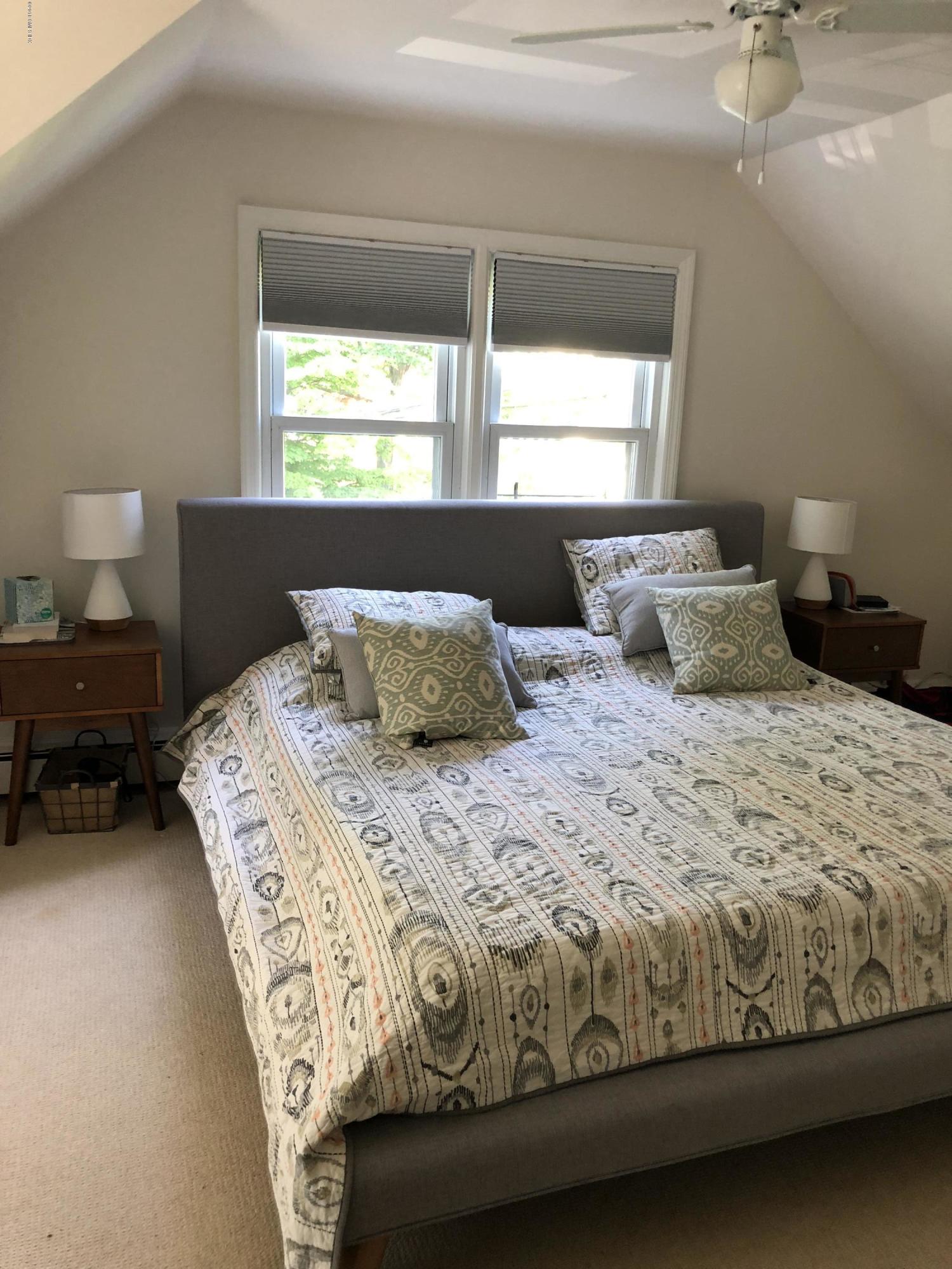 84 Indian Field Road Greenwich, CT 06830 - Photo 12 of 19 a bedroom with a bed and window