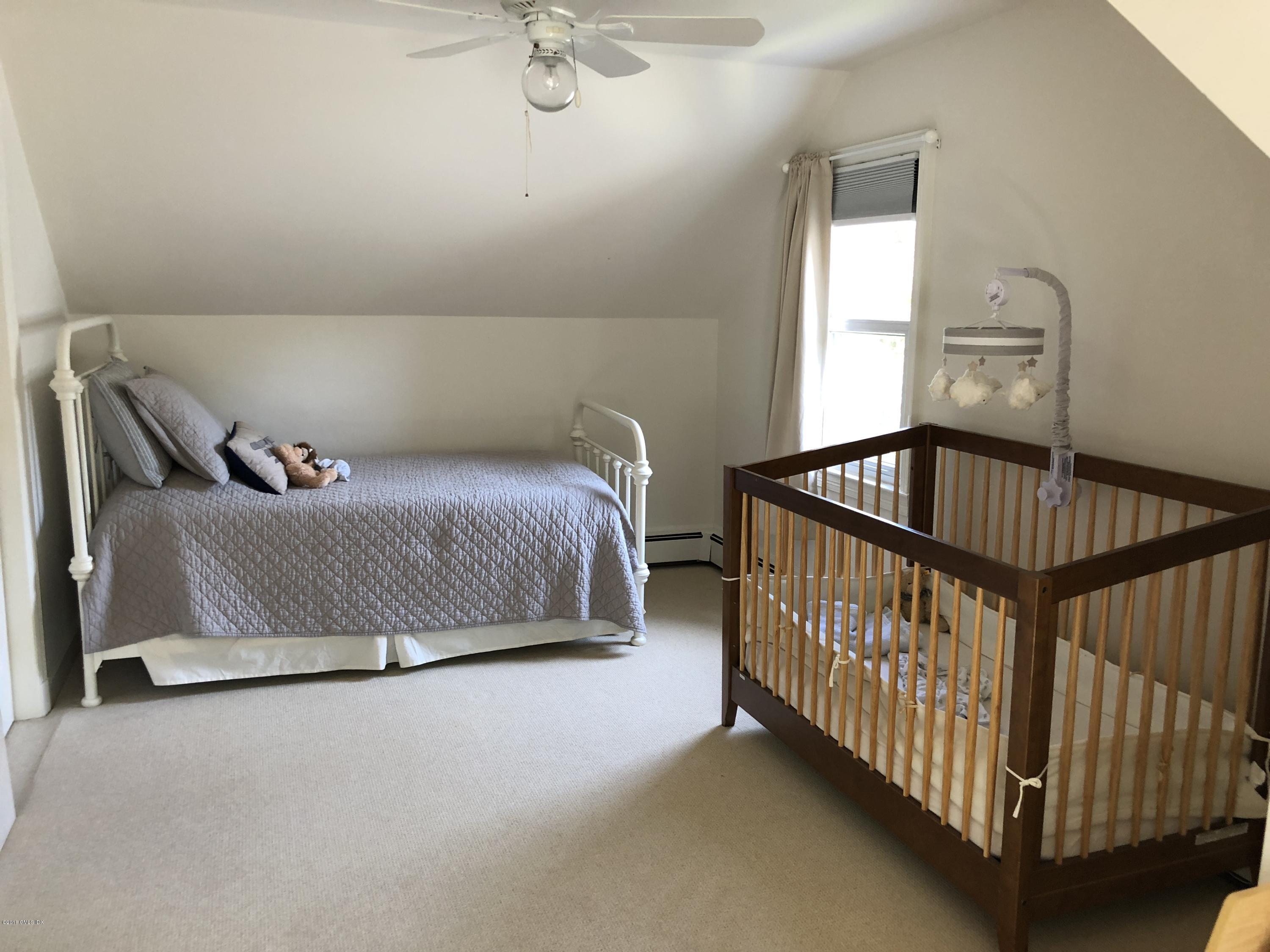 84 Indian Field Road Greenwich, CT 06830 - Photo 15 of 19 a bedroom with a bed and window