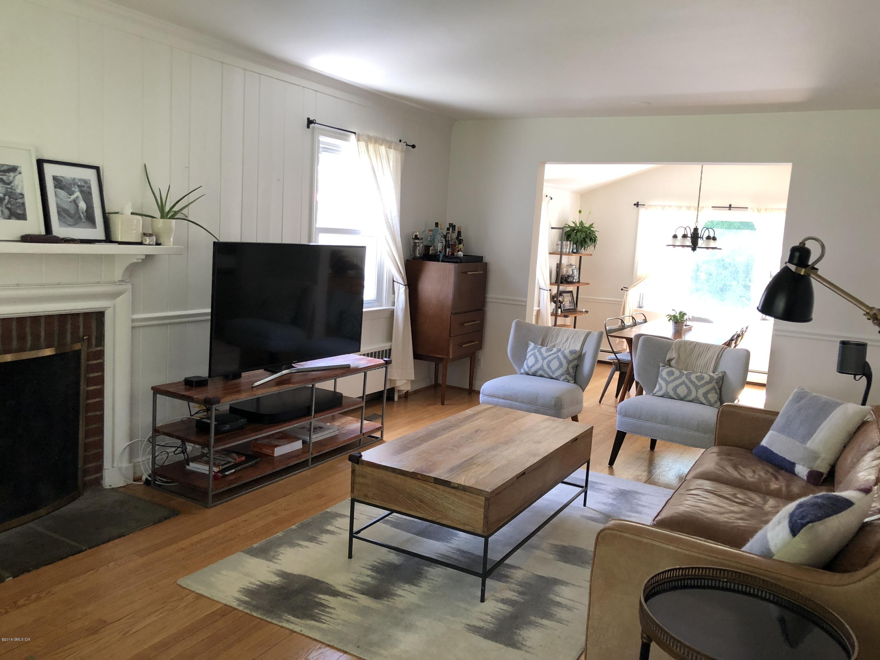 84 Indian Field Road Greenwich, CT 06830 - Photo 2 of 19 a living room with furniture and a flat screen tv