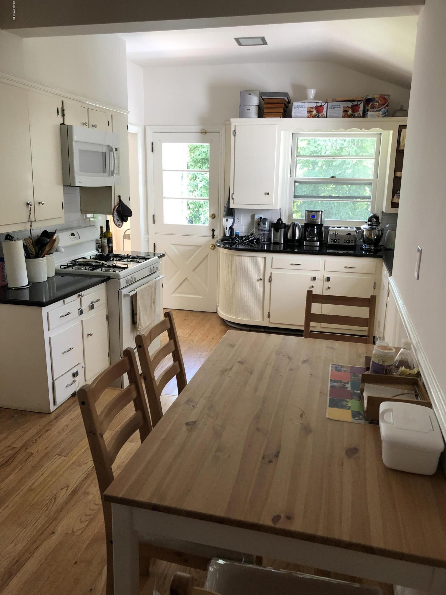 84 Indian Field Road Greenwich, CT 06830 - Photo 7 of 19 a kitchen with kitchen island a stove and a refrigerator