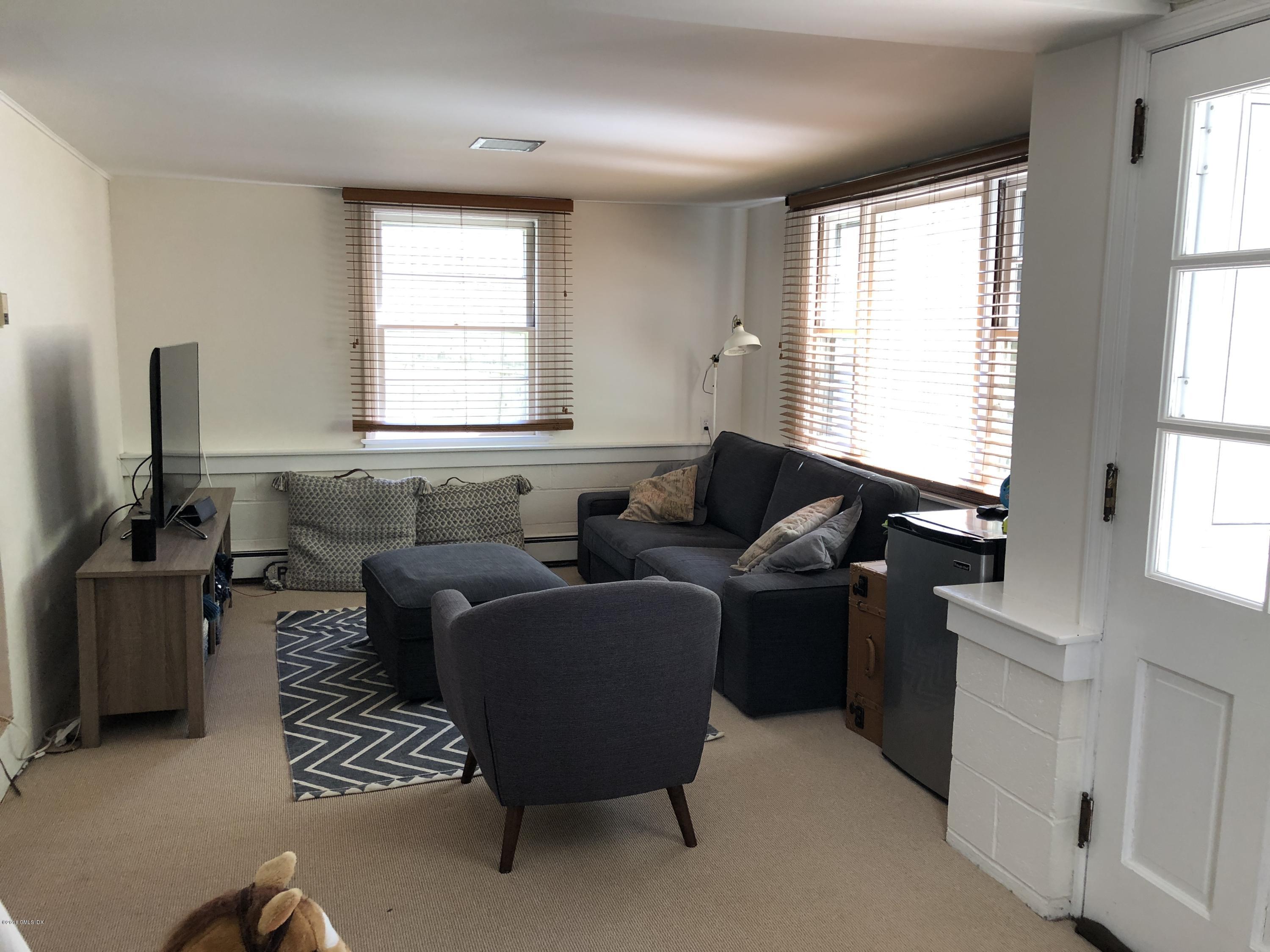 84 Indian Field Road Greenwich, CT 06830 - Photo 10 of 19 a living room with furniture and a window