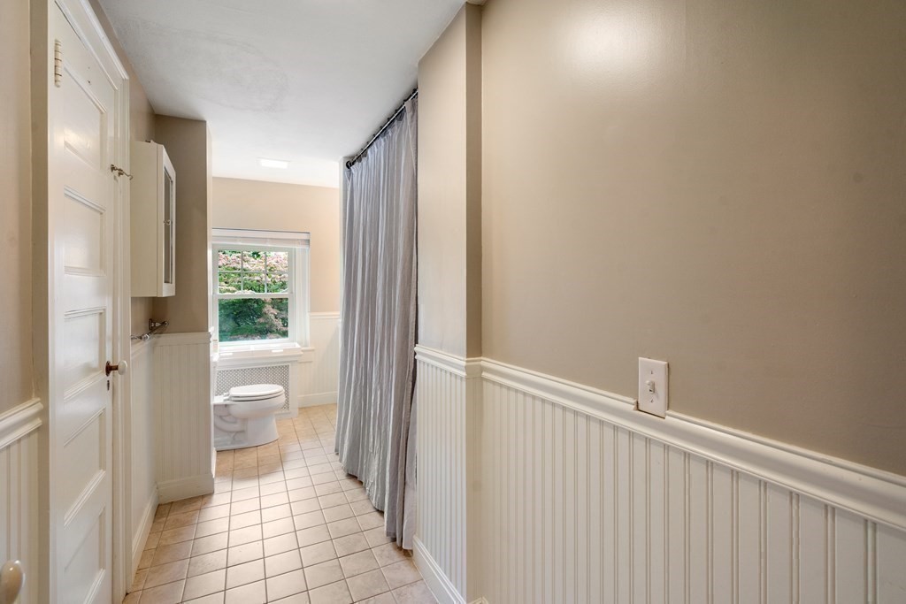 11 Hillside Road Wellesley, MA 02481 - Photo 23 of 29 a bathroom with a granite countertop shower and a toilet