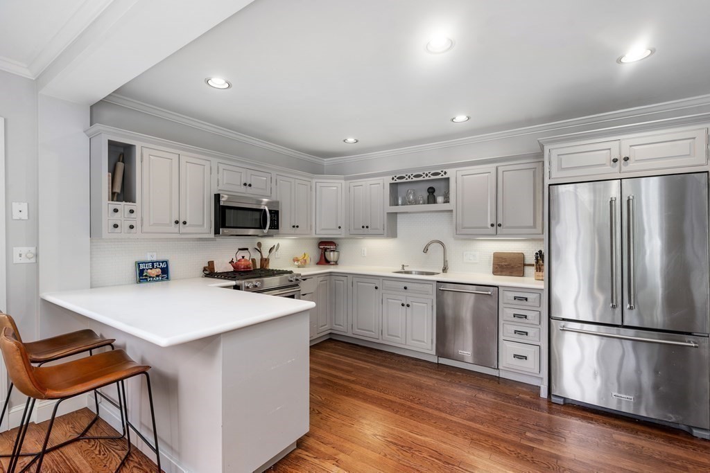 11 Hillside Road Wellesley, MA 02481 - Photo 7 of 29 a kitchen with stainless steel appliances a refrigerator stove microwave and cabinets