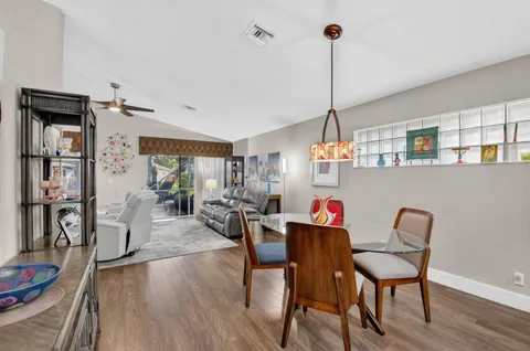 a kitchen with white cabinets sink and stainless steel appliances