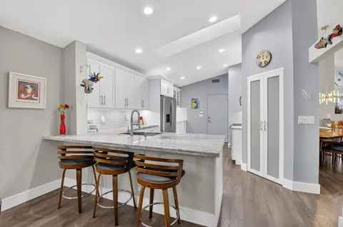a kitchen with stainless steel appliances granite countertop a refrigerator and a stove