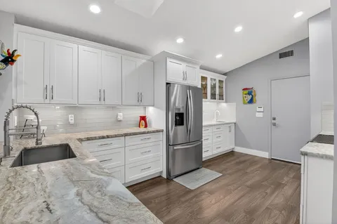 a kitchen with a refrigerator and cabinets