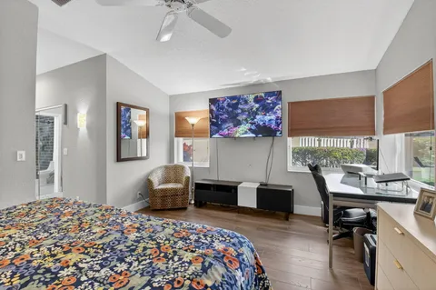 a bedroom with a bed and a painting on the wall