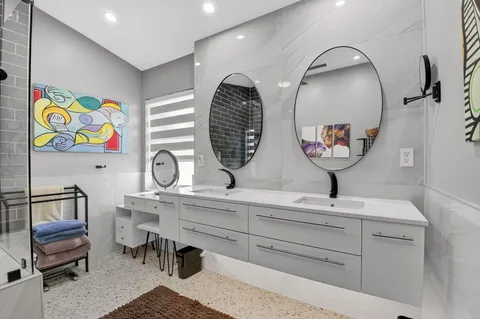 a view of a patio with table and chairs and a barbeque grill with floor to ceiling window and wooden fence