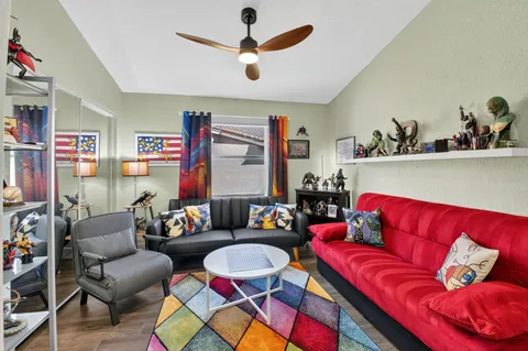 a living room with fireplace furniture and a wooden floor