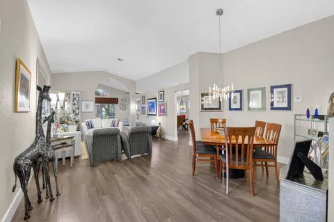 a living room with furniture a wooden floor and a large window
