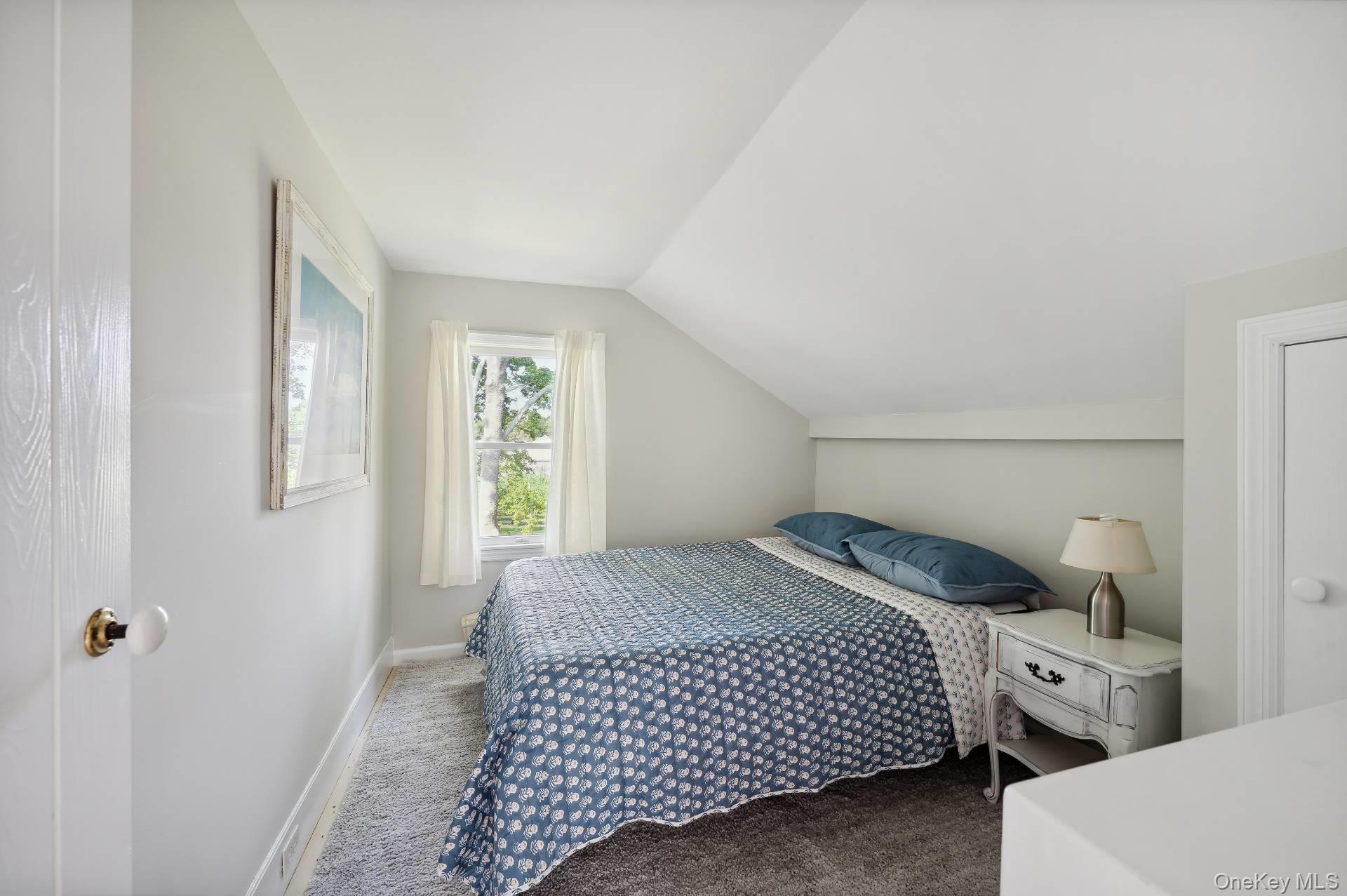 2600 Oregon Road Mattituck, NY 11952 - Photo 28 of 32 a bedroom with a bed and window