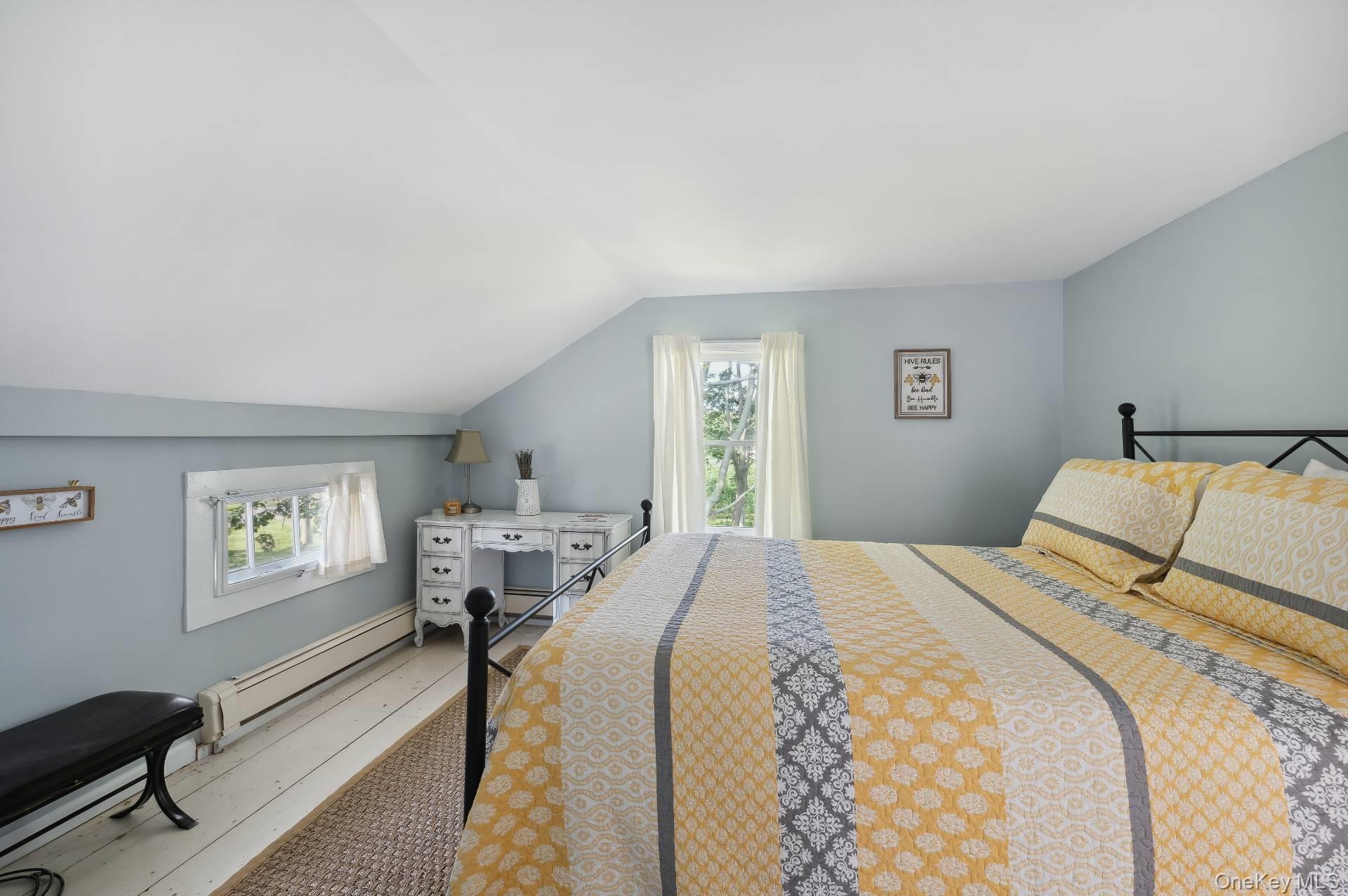2600 Oregon Road Mattituck, NY 11952 - Photo 29 of 32 a bedroom with a bed and a table in it