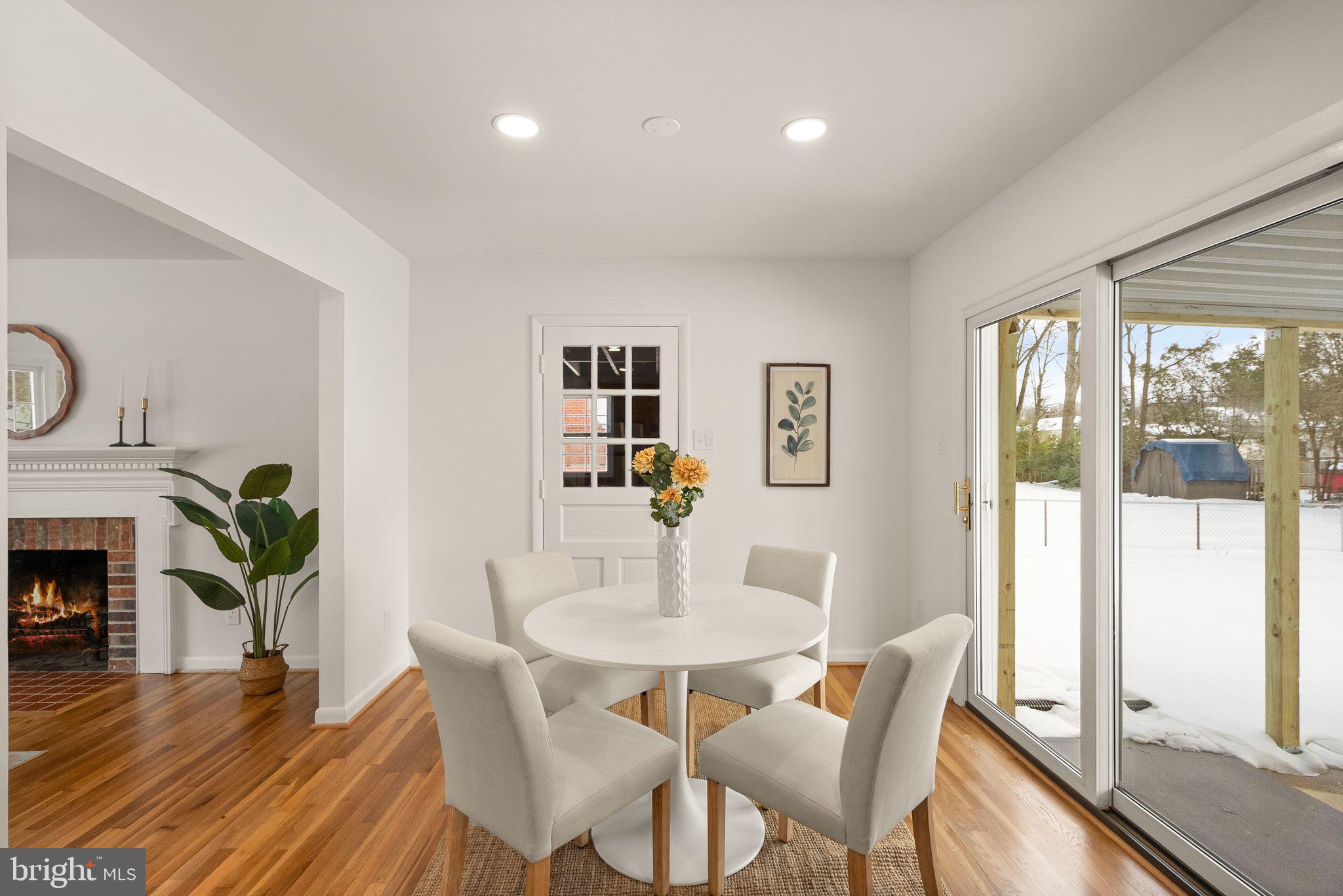 4217 Alcott Street Alexandria, VA 22309 - Photo 11 of 42 a dining room with furniture potted plants and wooden floor