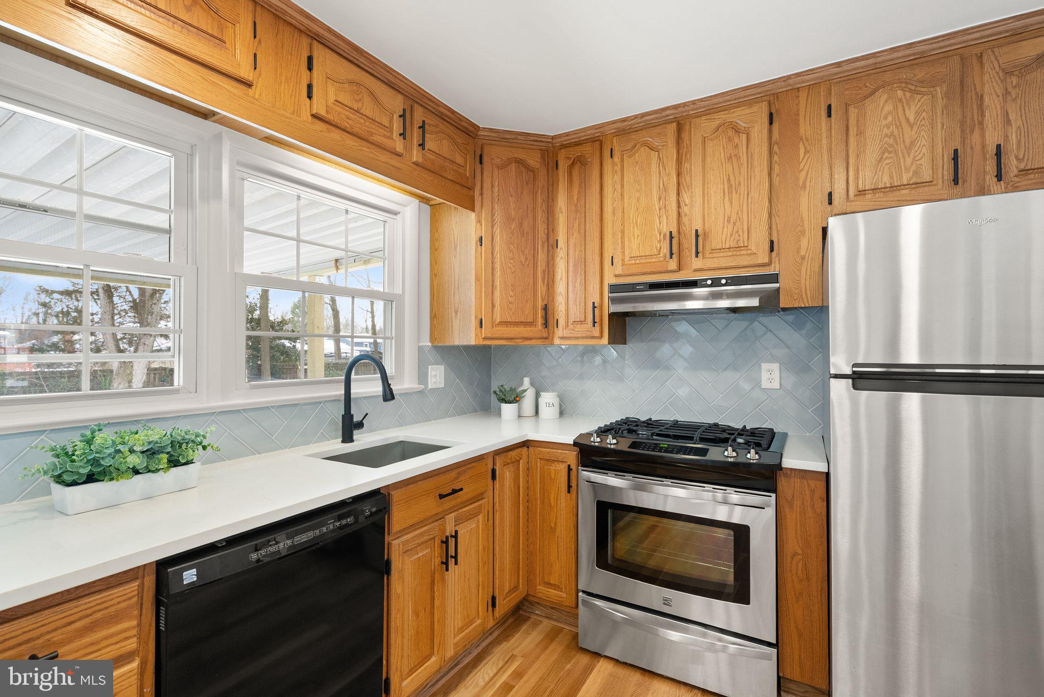 4217 Alcott Street Alexandria, VA 22309 - Photo 14 of 42 a kitchen with granite countertop a refrigerator stove and sink