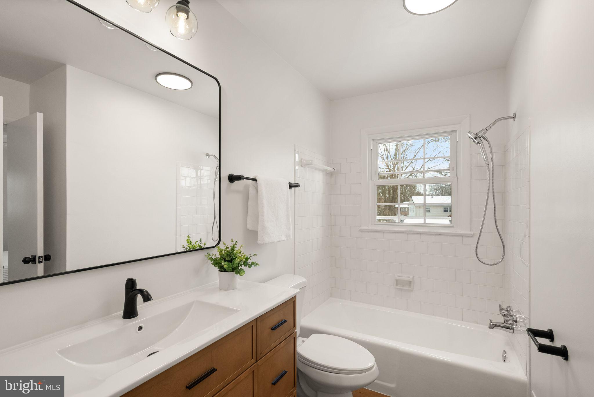 4217 Alcott Street Alexandria, VA 22309 - Photo 17 of 42 a bathroom with a bathtub shower sink vanity and toilet