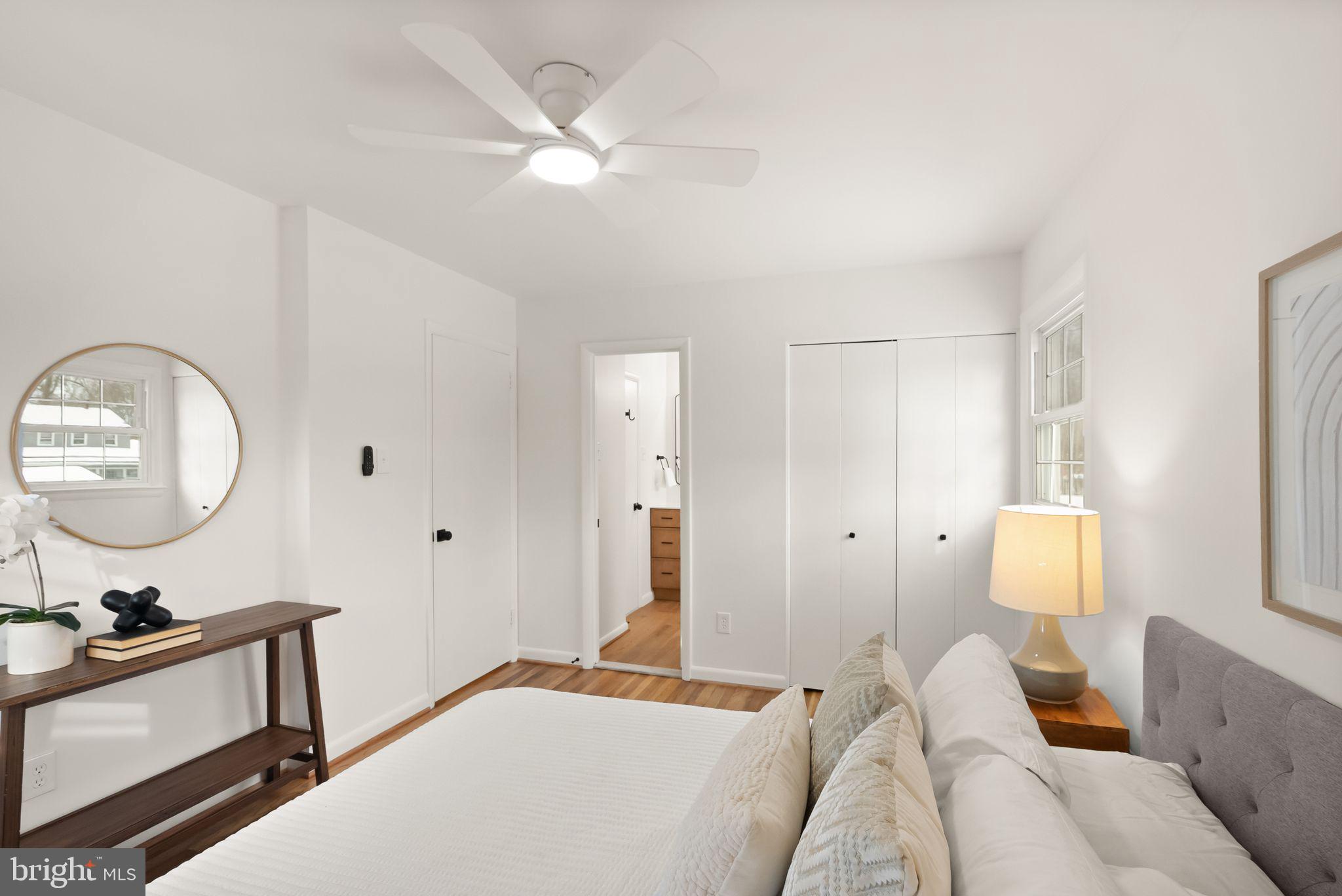 4217 Alcott Street Alexandria, VA 22309 - Photo 22 of 42 a bedroom with a bed a mirror and a potted plant