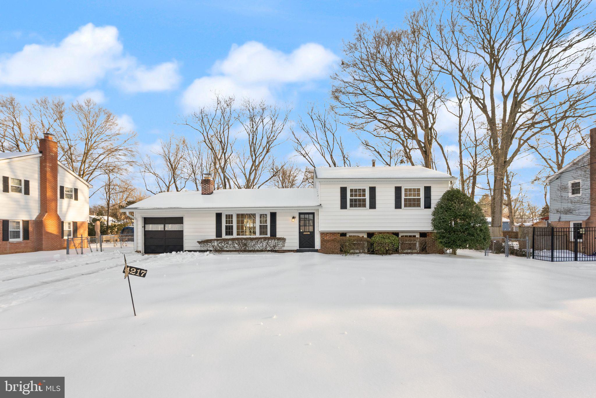4217 Alcott Street Alexandria, VA 22309 - Photo 40 of 42 a view of a white house with a large trees