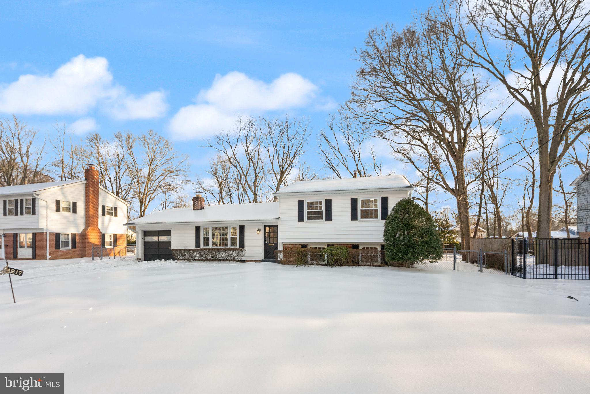 4217 Alcott Street Alexandria, VA 22309 - Photo 41 of 42 a view of a white house with a yard covered in snow