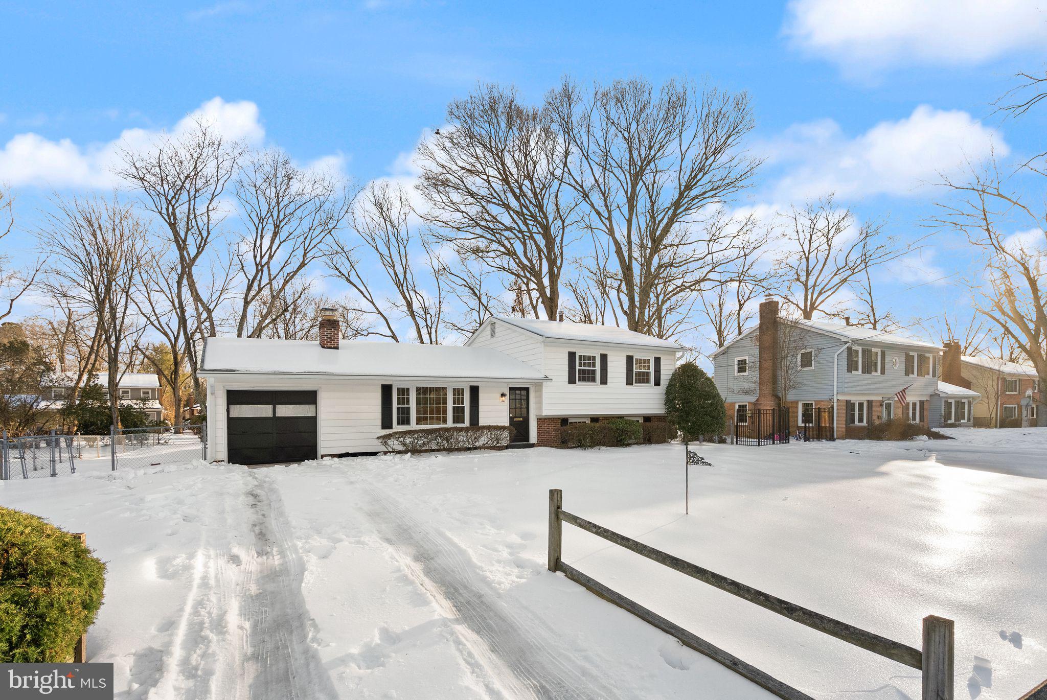 4217 Alcott Street Alexandria, VA 22309 - Photo 42 of 42 a view of a white house with a yard covered in snow