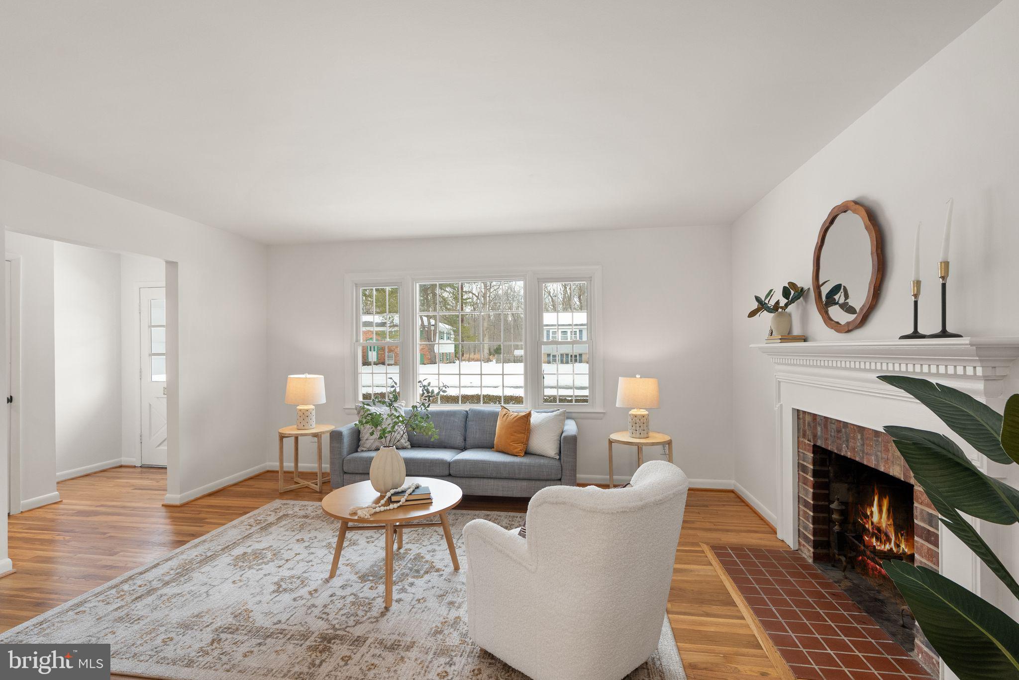 4217 Alcott Street Alexandria, VA 22309 - Photo 7 of 42 a living room with furniture a fireplace and a table
