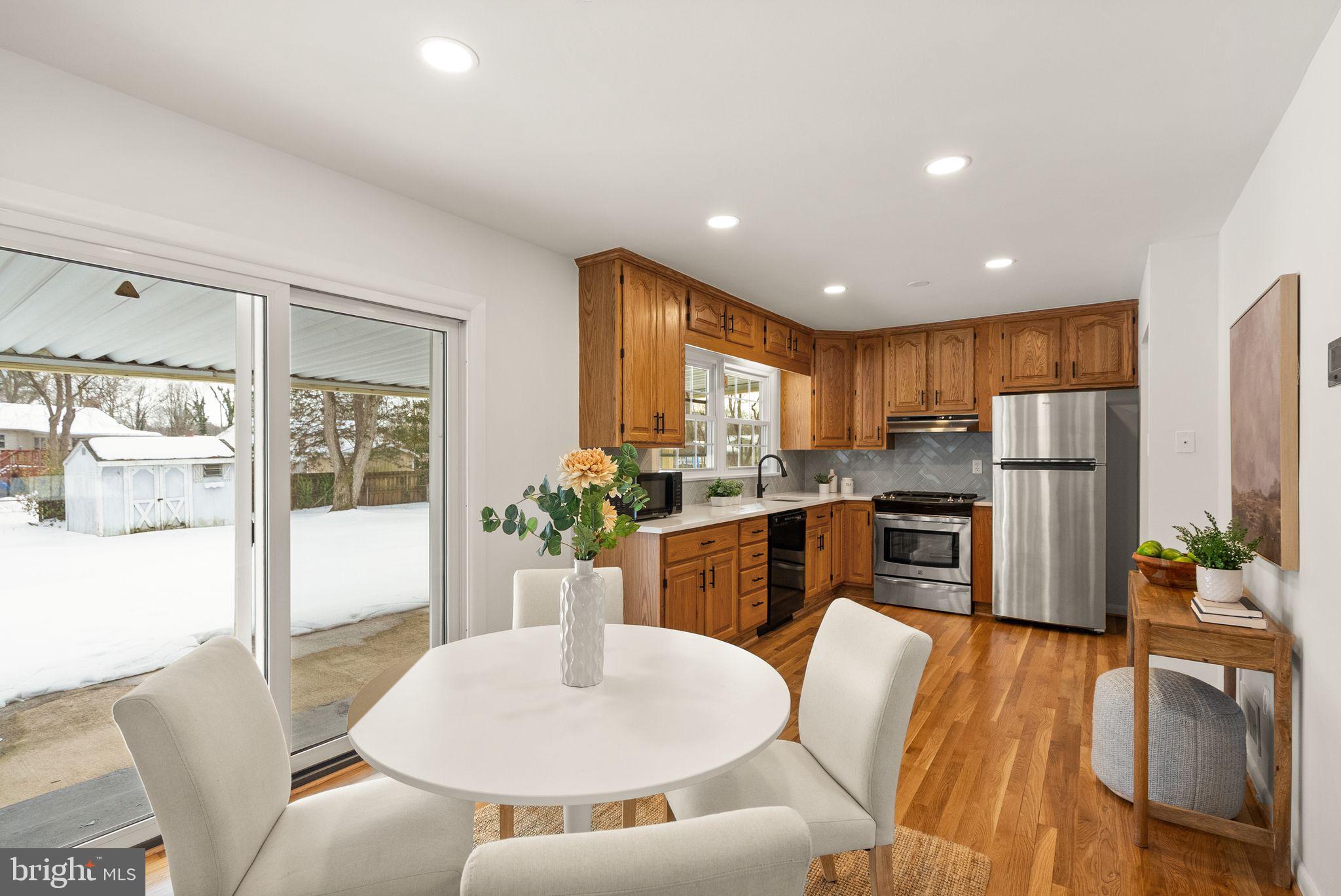 4217 Alcott Street Alexandria, VA 22309 - Photo 9 of 42 a living room with stainless steel appliances furniture a dining table and kitchen view
