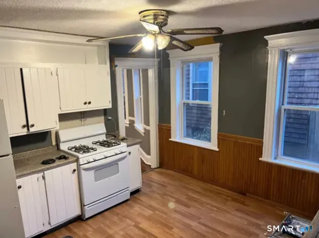 a kitchen with appliances cabinets and a table
