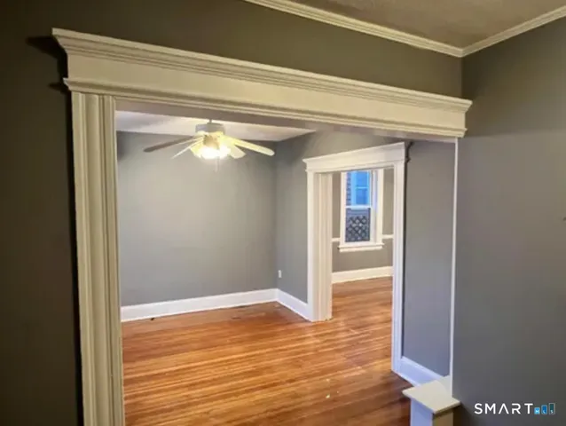 a view of a living room with wooden floor