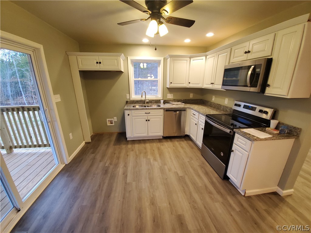 488 Guinea Road Farmville, VA 23901 - Photo 4 of 22 a kitchen with wooden floors and appliances