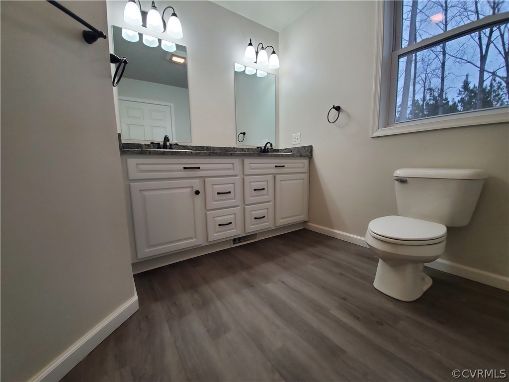 488 Guinea Road Farmville, VA 23901 - Photo 8 of 22 a bathroom with a toilet sink and mirror