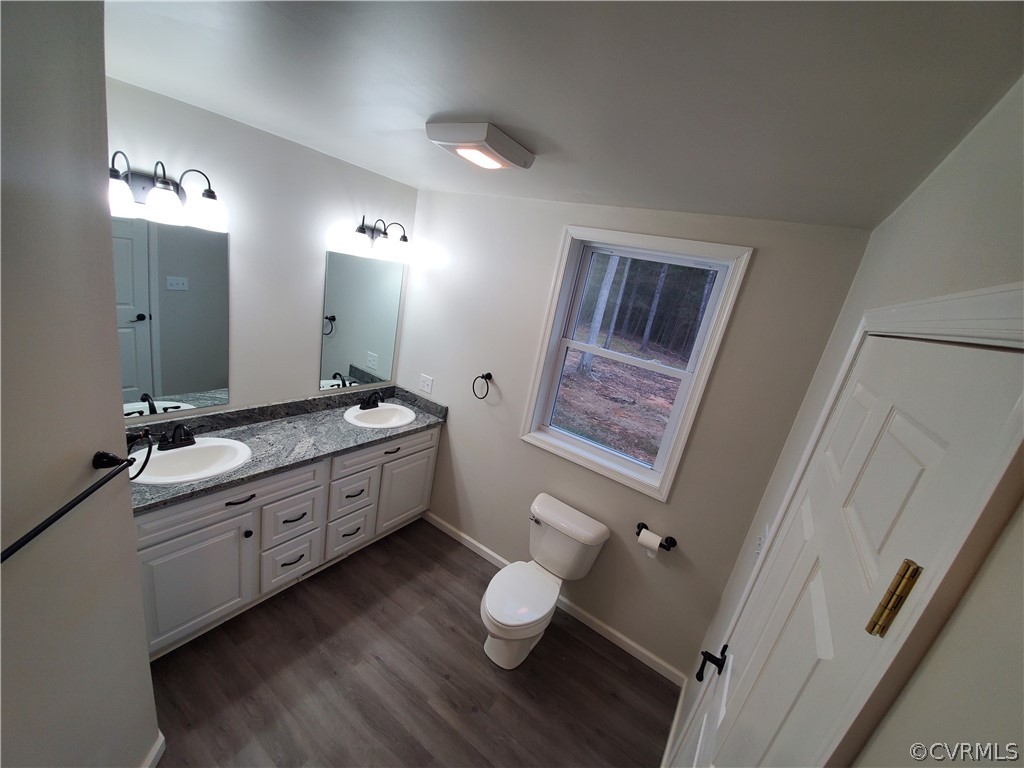 488 Guinea Road Farmville, VA 23901 - Photo 9 of 22 a bathroom with a granite countertop sink toilet a large mirror and a shower