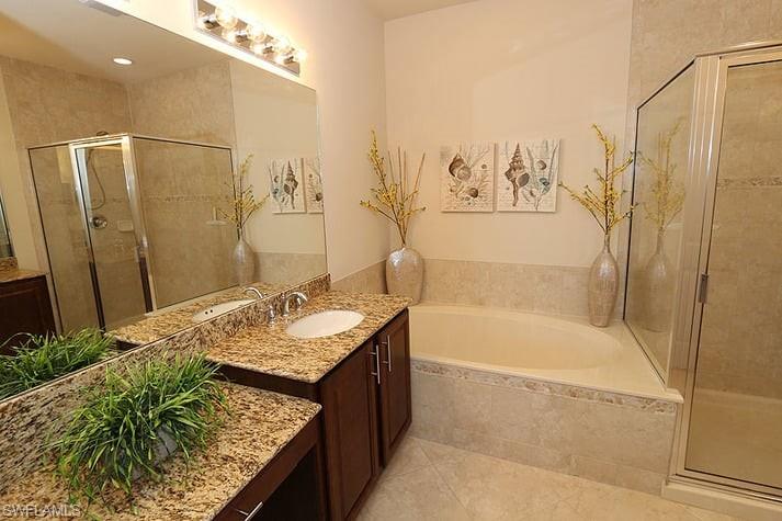 6525 Monterey Point, Unit 203 Naples, FL 34105 - Photo 12 of 25 Bathroom with vanity, plus walk in shower, and tile patterned flooring